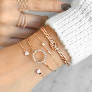 Knotted Arrow Open Circle of Rhinestones Open Pearls Four Piece Bracelet Set